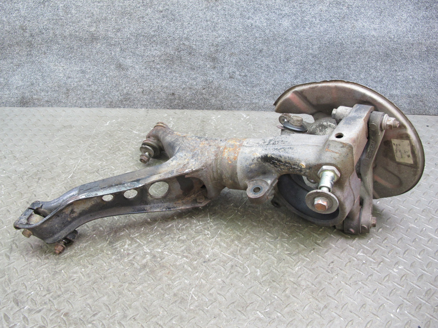 86-91 Mazda RX7 FC3S Rear Left Spindle Knuckle Wheel Hub w Trailing Arm Assy OEM