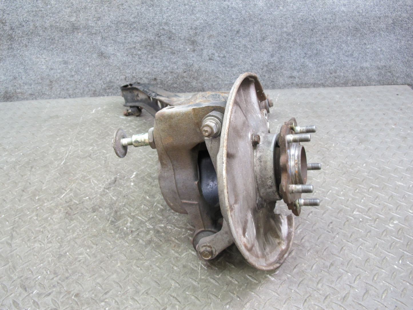 86-91 Mazda RX7 FC3S Rear Left Spindle Knuckle Wheel Hub w Trailing Arm Assy OEM