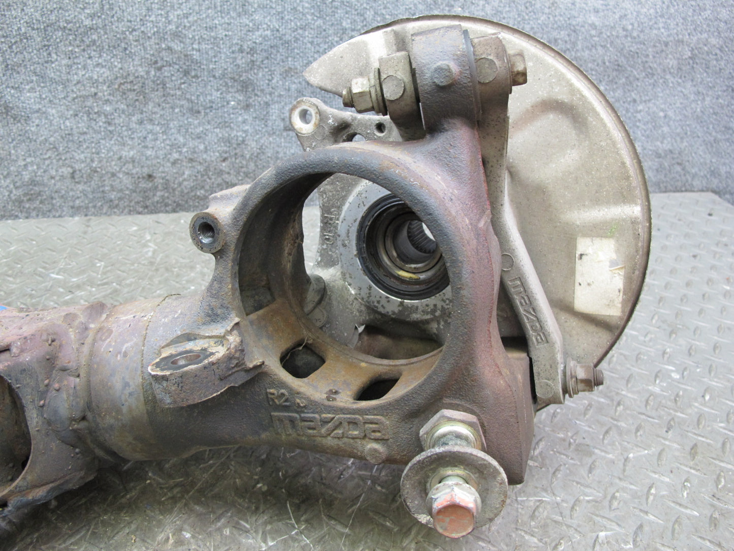 86-91 Mazda RX7 FC3S Rear Right Spindle Knuckle Wheel Hub w Trailing Arm OEM