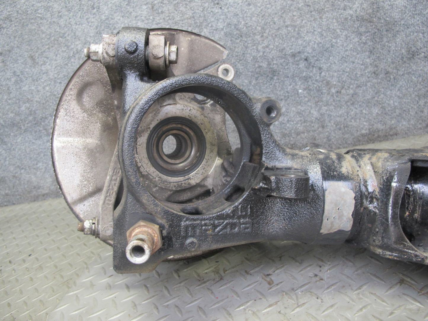 86-91 Mazda RX7 FC3S Rear Left Spindle Knuckle Wheel Hub w Trailing Arm OEM